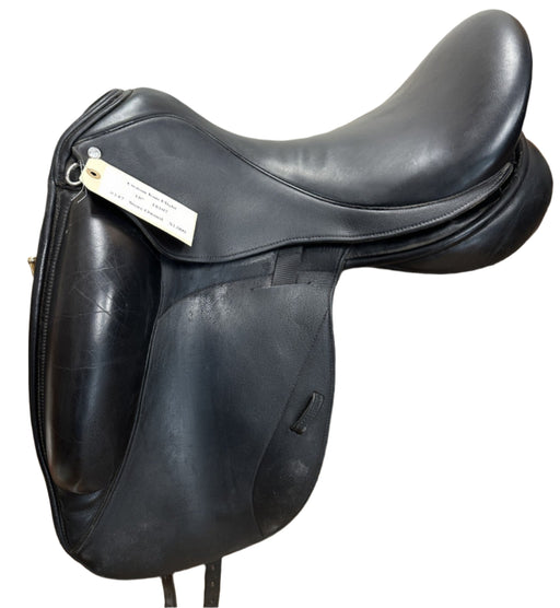 Black leather saddle on a wooden stand indoors